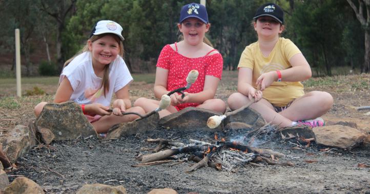 Kids cooking damper in a campfire at Lake Burrendong Sport and Recreation Centre